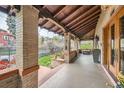 Spacious covered porch with brick pillars and views of the landscaped front yard at 680 N Emerson St, Denver, CO 80218