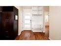Inviting entryway with wood floors, modern storage, and a stylish front door at 3390 Cranston Cir, Littleton, CO 80126