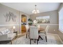 Cozy dining area with a round wood table, four upholstered chairs, and decor, open to the kitchen at 4053 S Riviera St, Aurora, CO 80018