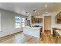 Bright, modern kitchen boasts a center island, pendant lighting, and stainless steel appliances at 23909 E 41St Ave, Aurora, CO 80019