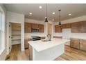 Modern kitchen features a large island, stainless steel appliances, and plenty of cabinet space at 23909 E 41St Ave, Aurora, CO 80019
