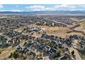 Expansive aerial view of a charming suburban neighborhood with mature trees and mountain views at 447 Winterthur Way, Highlands Ranch, CO 80129