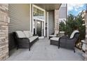 Cozy front porch showcases comfortable seating, creating an inviting outdoor space for relaxing and entertaining at 447 Winterthur Way, Highlands Ranch, CO 80129