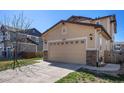 A spacious two car attached garage with stone detail on a charming home in a suburban neighborhood at 6370 Twilight Ave, Firestone, CO 80504