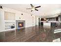 Spacious living room featuring a cozy fireplace and open floor plan leading into the kitchen at 6370 Twilight Ave, Firestone, CO 80504