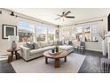 Bright and airy living room with large windows, comfortable seating and hardwood floors at 6370 Twilight Ave, Firestone, CO 80504