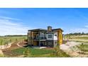 Beautiful modern home with large windows, a balcony and concrete patio in a large yard at 11115 Evening Hunt Rd, Franktown, CO 80116