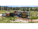 Modern home with a stone and wood facade, spiral staircase, balcony and outdoor patio at 11115 Evening Hunt Rd, Franktown, CO 80116