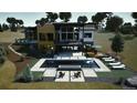 Aerial view of the backyard with a modern pool, lounge chairs, and a fire pit with lush landscaping at 11115 Evening Hunt Rd, Franktown, CO 80116