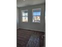 Bright bedroom with carpet flooring and two large windows at 498 Grey Rock St, Brighton, CO 80601