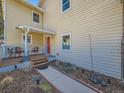 Charming front entrance with a red door, covered porch, and landscaped walkway at 2446 S Vaughn Way # A, Aurora, CO 80014