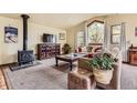 Bright living room with large windows, a wood stove, and comfortable seating at 4 Virginia St, Idaho Springs, CO 80452