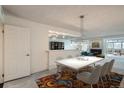 Open dining room featuring contemporary lighting, seating for six, and seamless flow to the living area at 7000 E Quincy Ave # 317, Denver, CO 80237
