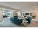 Inviting living room features a fireplace, plush seating, and ample natural light at 7000 E Quincy Ave # 317, Denver, CO 80237