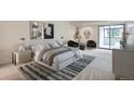 Serene main bedroom showcasing neutral tones, stylish decor, and access to a private balcony at 7000 E Quincy Ave # 317, Denver, CO 80237