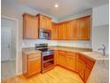 Well-lit kitchen showcasing wood cabinets, granite countertops, and stainless steel appliances at 11649 E 111Th Ave, Commerce City, CO 80640