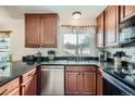Stylish kitchen featuring granite countertops, stainless steel appliances, and natural light at 16816 E Villanova Cir, Aurora, CO 80013