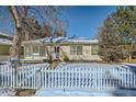 Cute ranch home with a white picket fence and snowy yard at 2253 Columbine Ave, Boulder, CO 80302