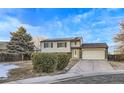 House exterior view, featuring a two-car garage and a well-maintained lawn at 12263 Clermont Ct, Thornton, CO 80241