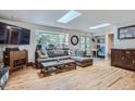 Bright living room with hardwood floors, skylights, and large windows offering scenic views at 2013 Swede Gulch Rd, Evergreen, CO 80439