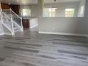 Bright and airy living room featuring luxury vinyl plank flooring and an open floorplan adjacent to the kitchen at 9768 Mayfair St # E, Englewood, CO 80112