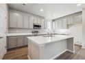 Stylish kitchen showcases ample cabinetry, stainless steel appliances, and a large center island at 2283 Serenidad St, Brighton, CO 80601