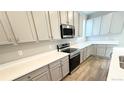 Modern kitchen with stainless steel appliances, light cabinets, and solid surface counters at 2283 Serenidad St, Brighton, CO 80601