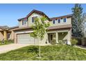 Two-story home with a well-manicured lawn and inviting front porch, enhanced by the young tree at 5327 Suffolk Cir, Castle Rock, CO 80104