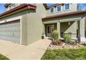 Inviting front porch with space for seating, surrounded by charming landscaping and attractive exterior paint at 5327 Suffolk Cir, Castle Rock, CO 80104