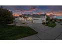Charming home exterior featuring a well-manicured lawn and attached two-car garage at 8258 S Sicily Ct, Aurora, CO 80016