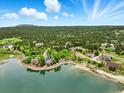 Picturesque aerial view of lakeside homes surrounded by lush forests, showcasing a serene setting at 18590 Lower Lake Rd, Monument, CO 80132