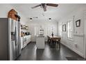 Bright kitchen featuring stainless steel fridge, an island and a dining area at 9551 W 38Th Ave, Wheat Ridge, CO 80033