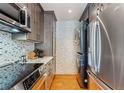Modern kitchen including updated appliances, hardwood floors, and adjacent laundry setup at 405 Village Rd # 405, Breckenridge, CO 80424
