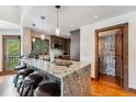 Open kitchen featuring granite counters, pendant lighting, modern appliances, and bar stool seating at 405 Village Rd # 405, Breckenridge, CO 80424