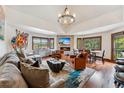 Spacious living room with a stone fireplace, mounted tv and an abundance of natural light at 405 Village Rd # 405, Breckenridge, CO 80424