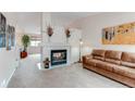 Cozy living room featuring a fireplace, neutral carpet, and comfortable seating at 10652 Hyacinth St, Highlands Ranch, CO 80129