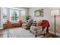 Cozy living room featuring bay window, hardwood floors, and comfortable seating at 1820 Cooper Ct, Castle Rock, CO 80109