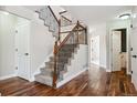 Elegant staircase with wrought iron railing and hardwood floors at 1820 Cooper Ct, Castle Rock, CO 80109