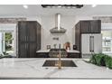 Modern kitchen featuring stainless steel appliances, marble countertops, and stylish backsplash at 1024 W 8Th Ave, Denver, CO 80204