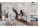 Bright and open living area showcasing hardwood floors, modern lighting, and staircase at 1024 W 8Th Ave, Denver, CO 80204