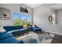 Cozy living room featuring modern décor, a large window, and hardwood floors at 6712 Zuni St, Denver, CO 80221