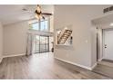 Open-concept living room with vaulted ceilings, wood floors, and a sliding glass door to the outside deck at 3539 S Fairplay Way # 10, Aurora, CO 80014