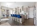 Modern kitchen featuring a large island with seating and stylish pendant lighting at 5026 S Platte River Pkwy, Littleton, CO 80123