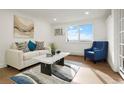 Inviting living room with comfortable seating, a stylish rug, and serene window view at 3047 W 47Th Ave # 607, Denver, CO 80211