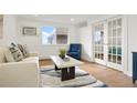 Cozy living room with a plush sofa, accent chair, and view from large window at 3047 W 47Th Ave # 607, Denver, CO 80211