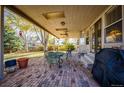 Wonderful covered patio featuring a brick floor and elegant ceiling fans for outdoor relaxation at 6454 S Nelson Way, Littleton, CO 80127