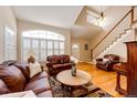 Bright living room featuring a cozy seating area, hardwood floors, and plenty of natural light at 6454 S Nelson Way, Littleton, CO 80127