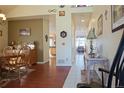 Traditional dining room featuring hardwood floors, a wooden table set, and a glimpse of a well-lit hallway at 16873 Boreas Ct, Parker, CO 80134