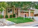 Charming two-story home with well-manicured lawn, mature tree, and inviting curb appeal at 16873 Boreas Ct, Parker, CO 80134