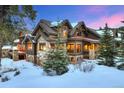 Beautiful stone and wood-paneled home featuring snowy landscaping and an inviting outdoor space at 59 Gold Run Rd, Breckenridge, CO 80424